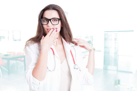 Portrait of seductive female doctor with eyeglasses and medical uniformの写真素材