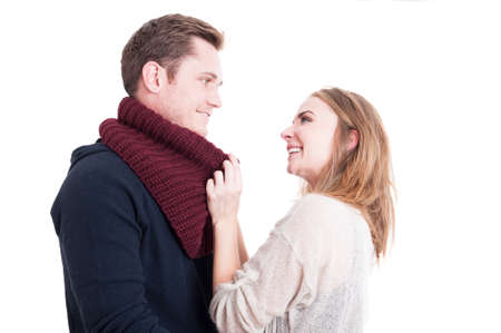 Woman arranging man's autumn casual neckcloth  and smiling like being comfy isolated on white backgroundの写真素材