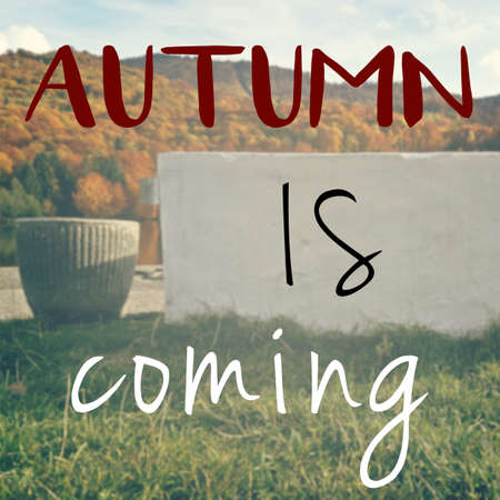 Autumn is here inspirational message on blurred background with natural landscapeの写真素材