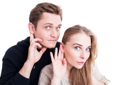 Handsome couple making listening gesture looking amazed isolated on white background with copy text spaceの写真素材