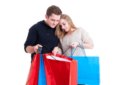 Couple looking in shopping bags and being content isolated on white background with copy text spaceの写真素材