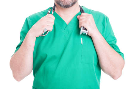 Unknown male doctor in green medical uniform holding his stethoscope isolated on whiteの写真素材
