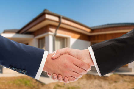 Business people shaking hands after estate meeting for a new collaboration in closeup view with copyspaceの写真素材