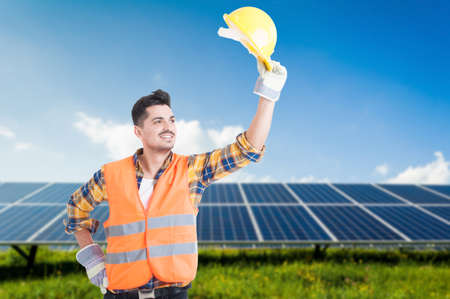 Smiling engineer doing salutation or welcoming gesture outside near solar power station with copy...
