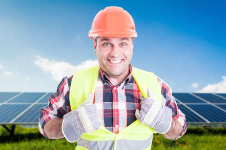 Cheerful male engineer acting like super hero while being at solar station as green electricity conceptの写真素材