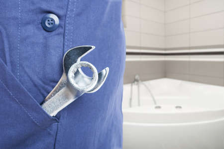 Close-up of plumber steel spanner and wrench in the bathroom with advertising areaの写真素材