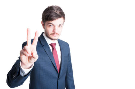 Marketing manager or sales man making peace gesture isolated on white background with copy advertising areaの写真素材