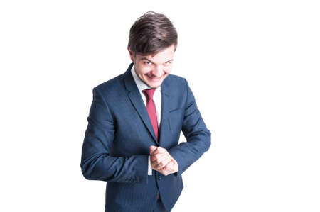 Sales man wearing making evil look and gesture like winning something isolated on white background with copy text areaの写真素材