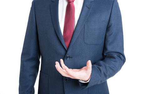 Close-up of business man standing and holding something and smiling isolated on white background with copy advertising areaの写真素材