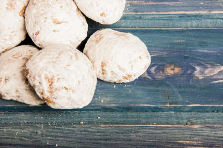 Sweet gingerbreads in glaze on wooden table with text or advertising areaの写真素材