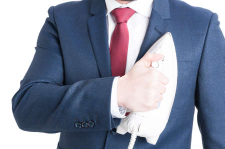 Close-up of man wearing suit holding iron oh his jacket isolated on white backgroundの写真素材