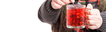 Closeup view of male hand doing hot tea and treating his cold isolated on white with copy text spaceの写真素材