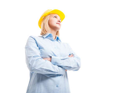 low angle hero shot of female engineer posing with arms crossed being serious isolated on white background with copy text spaceの写真素材