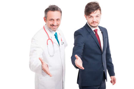 Business man shaking hands with medical staff in background on white backgroundの写真素材
