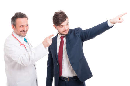 Friendly team with doctor or medic and handsome businessman pointing finger at something on white backgroundの写真素材