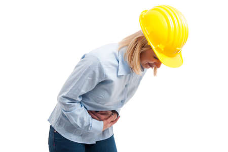 Woman architect bending for pain holding her stomach like suffering isolated on white background