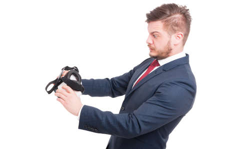 Handsome businessman looking scared after using 3d virtual glasses isolated on whiteの写真素材