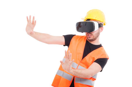 Male builder wearing futuristic vr glasses and doing rejection gesture isolated on whiteの写真素材