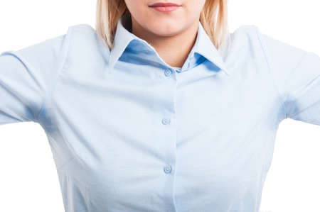 Close-up of female wearing shirt showing sweat stains isolated on white backgroundの写真素材