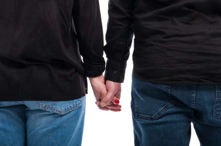 Close up of couple holding hands together as love concept isolated on whiteの写真素材