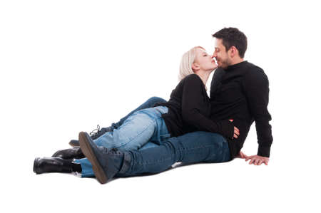 Two people sitting close to each other and showing affection isolated on white backgroundの写真素材