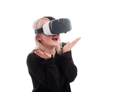Pretty girl experiencing virtual reality through VR headset isolated on white background with copytextの写真素材