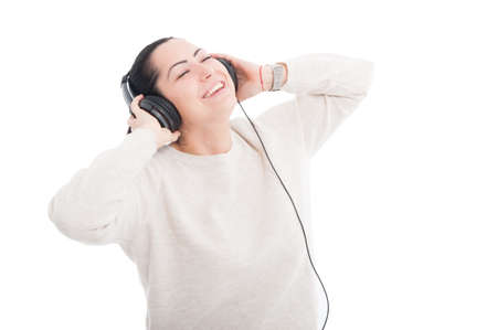 Girl having relaxing moments with headphones enjoying music isolated on white backgroundの写真素材