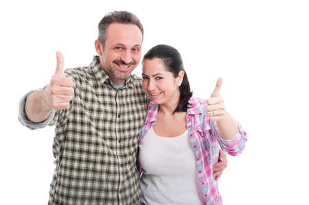 Romantic man and female laughing together and showing thumb up on white studio backgroundの写真素材