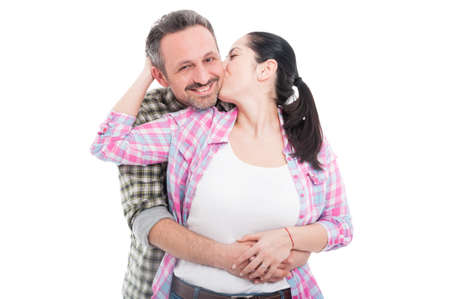 Young loving couple with female kissing her man with passion isolated on white