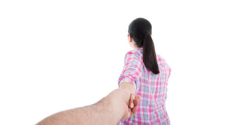Woman holding hand of husband following her in view from behind on white background with copyspaceの写真素材