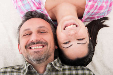 Top view of young couple in romantic moment looking at camera and smilingの写真素材