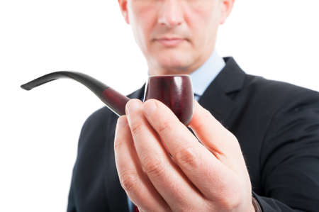 Close-up of middle age man holding a pipe isolated on white backgroundの写真素材
