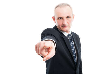 Portrait of middle age elegant man pointing camera wearing suit and tie isolated on white background with copy text spaceの写真素材