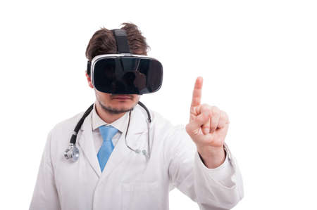 Medical intern using virtual reality glasses and pointing on virtual screen on white backgroundの写真素材