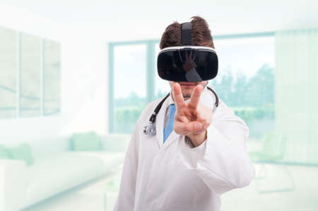 Young medic with futuristic headset pointing fingers at you as spying conceptの写真素材