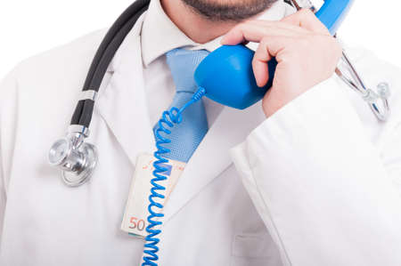 Close-up of medical doctor with euros in coat calling somebody for an appointmentの写真素材