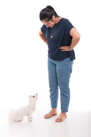 Full body of attractive female with her dog and looking at each other isolated on white