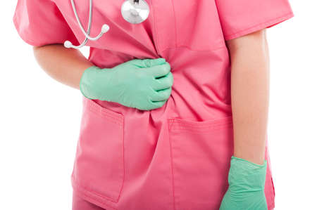 Close-up of nurse holding her stomach like hurting isolated on white background