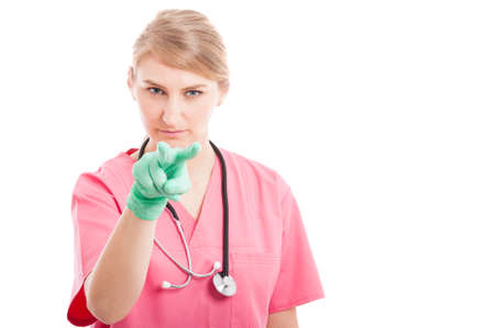 Female medical nurse showing watching you gesture isolated on white background with copy text spaceの写真素材