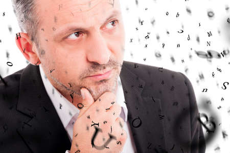 Pensive young man with abstract letters in closeup view as thoughts and brainstorming conceptの写真素材