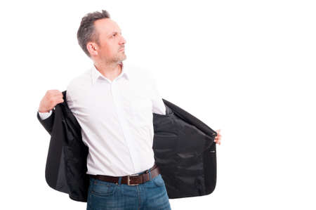 Attractive man taking off his suit jacket with a confident attitude on white backgroundの写真素材