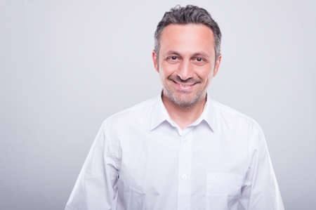 Engineer posing wearing white shirt and smiling on grey background with copy text spaceの写真素材