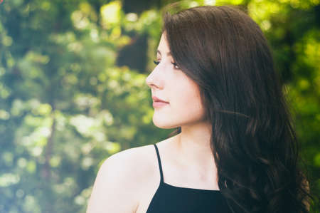 Summer girl portrait in sunny summer or spring day outside in the woods with copyspaceの写真素材