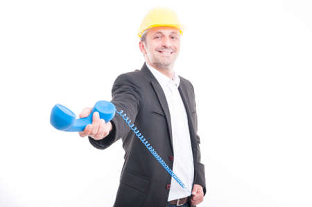 Portrait of architect showing big blue telephone receiver and smiling isolated on white background with copy text spaceの写真素材
