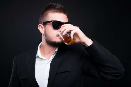 Glamorous handsome male drinking expensive whiskey as high exclusive lifestyle concept