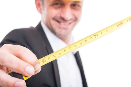 Close-up of architect showing measuring tape and smiling isolated on white backgroundの写真素材