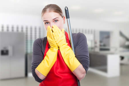 Young cleaner looking very surprised of something in the kitchen