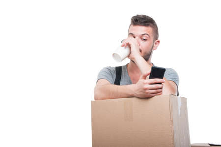 Mover man drinking coffee and texting on boxes isolated on white background with copy text space