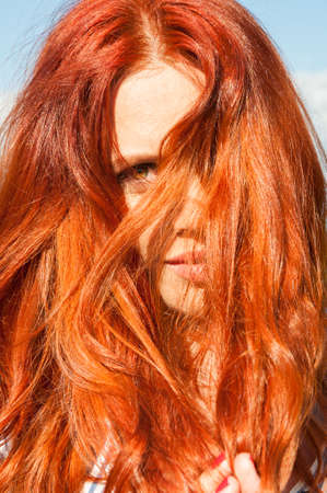 Closeup of redhead female relaxing outside on summer timeの写真素材