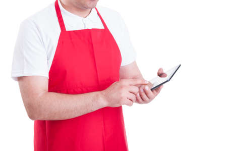 Hypermarket merchandiser with tablet pc at work ordering missing products on white backgroundの写真素材